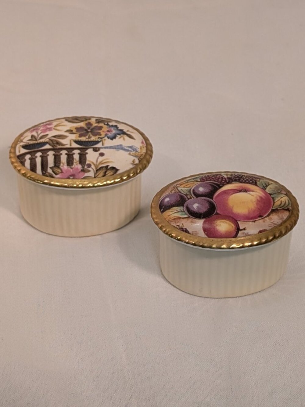 These vintage round lidded porcelain boxes feature classic English floral and fr